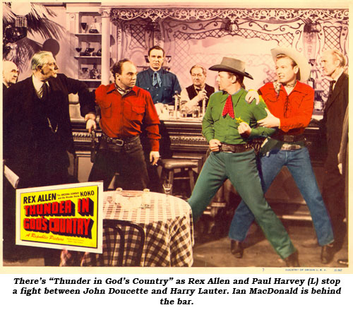 There's "Thunder in God's Country" as Rex Allen and Paul Harvey (L) stop a fight between John Doucette and Harry Lauter. Ian MacDonald is bhind the bar.