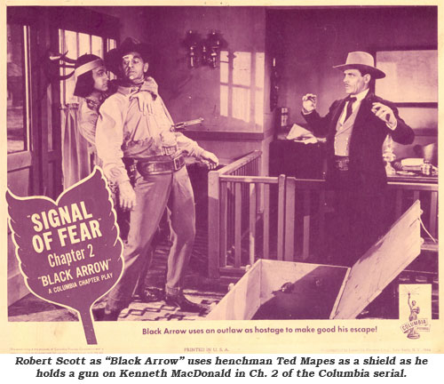 Robert Scott as "Black Arrow" uses henchman Ted Mapes as a shield as he holds a gun on Kenneth MacDonald in Ch. 2 of the Columbia serial.