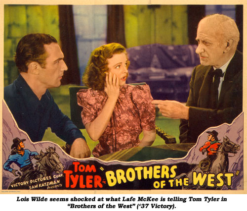 Lois Wilde seems shocked at what Lafe McKee is telling Tom Tyler in "Brothers of the West" ('37 Victory).