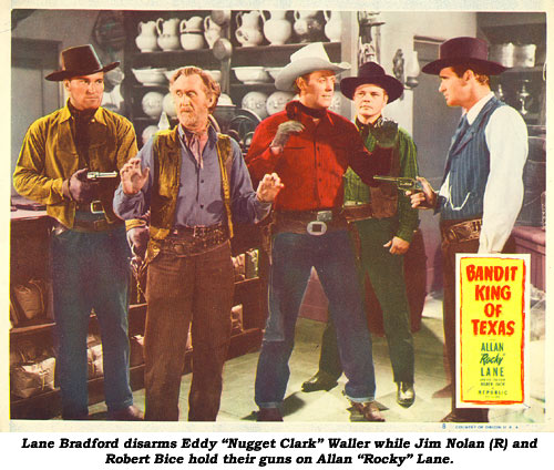 Lane Bradford disarms Eddy "Nugget Clark" Waller while Jim Nolan (r) and Robert Bice hold their guns on Allan "Rocky" Lane in the scene card from "Bandit King of Texas".
