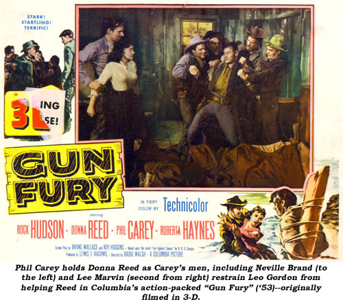 Phil Carey holds Donna Reed as Carey's men, including Neville Brand (to the left) and Lee Marvin (second from right) restrain Leo Gordon from helping Reed in Columbia's action-packed "Gun Fury" ('53)--originally filmed in 3-D.