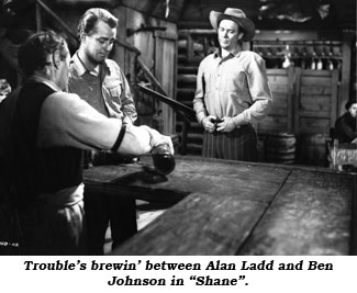 Trouble's brewin' between Alan Ladd and Ben Johnson in "Shane".