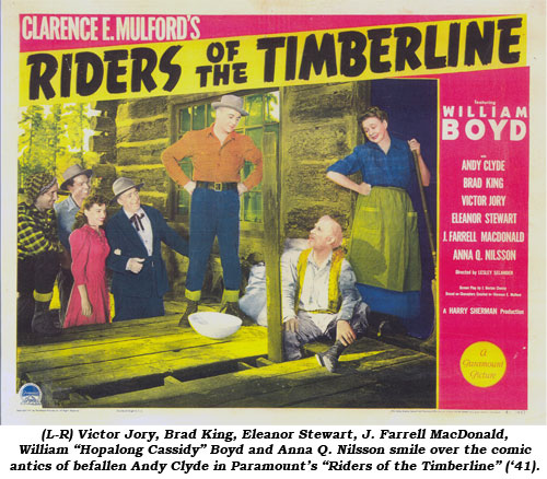 (L-R) Victor Jory, Brad King, Eleanor Stewart, J. Farrell MacDonald, William "Hopalong Cassidy" Boyd and Anna Q. Nilsson smile over the comic antics of befallen Andy Clyde in Paramount's "Riders of the Timberline" ('41).