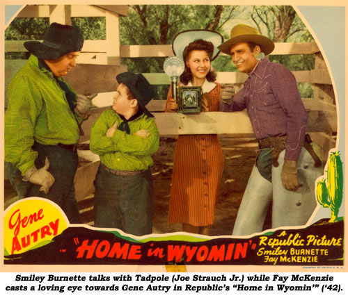 Smiley Burnette talks with Tadpole (Joe Strauch Jr.) while Fay McKenzie casts a loving eye towards Gene Autry in Republic's "Home in Wyomin'" ('42).