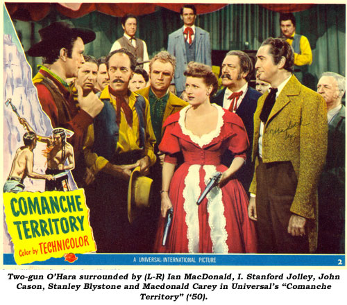 Two-gun O'Hara surrounded by (L-R) Ian MacDonald, I. Stanford Jolley, John Cason, Stanley Blystone and Macdonald Carey in Universal's "Comanche Territory" ('50).