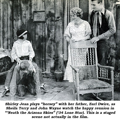 Shirley Jean plays "horsey" with her father, Earl Dwire, as Sheila Terry and John Wayne watch the happy reunion in "'Neath the Arizona Skies" ('34 Lone Star). This is a staged scene not actually in the film.