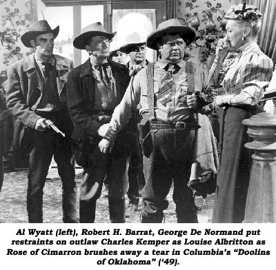 Al Waytt (left), Robert H. Barrat, George De Normand put restraints on outlaw Charles Kemper as Louise Albritton as Rose of Cimarron brushes away a tear in Columbia's "Doolins of Oklahoma".