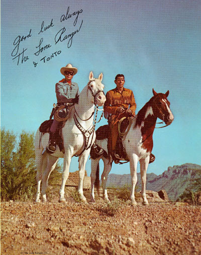 Autographed color photo of Clayton Moore and Jay Silverheels (The Lone Ranger and Tonto) mounted on Silver and Scout respectively.