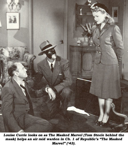 Louise Currie looks on as The Masked Marvel (Tom Steele behind the mask) helps an air raid warden in Ch. 1 of Republic's "The Masked Marvel" ('43).