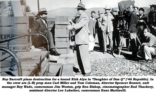 Roy Barcroft plans destruction for a bound Kirk Alyn in "Daughter of Don Q" ('46 Republic). In the crew are (L-R) prop men Carl Miller and Tom Coleman, director Spencer Bennet, unit manager Roy Wade, cameraman Jim Weston, grip Ben Bishop, cinematographer Bud Thackery, assistant director Lee Lukather, cameraman Enzo Martinelli.