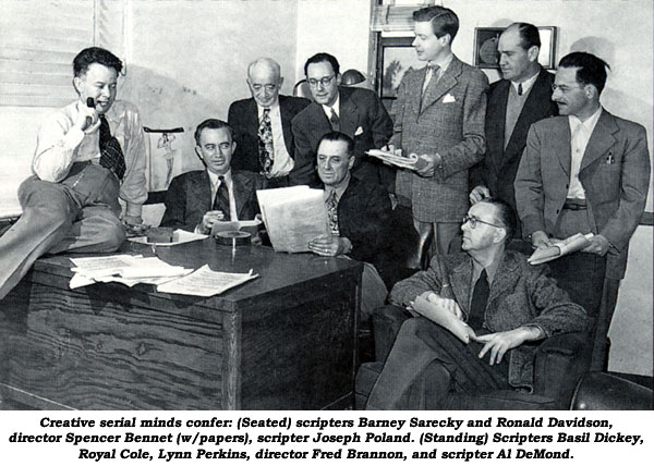 Creative serial minds confer: (seated) scripters Barney Sarecky and Ronald Davidson, director Spencer Bennet (w/papers), scripter Joseph Poland. (Standing) Scripters Basil Dickey, Royal Cole, Lynn Perkins, director Fred Brannon, and scripter Al DeMond.
