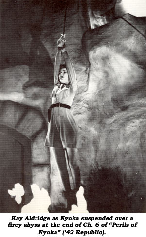 Kay Aldridge as Nyoka suspended over a firey abyss at the end of Ch. 6 of "Perils of Nyoka" ('42 Republic).
