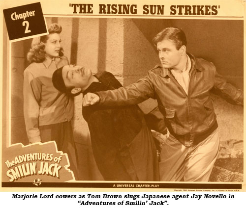 Marjorie Lord cowers as Tom Brown slugs Japanese agent Jay Novello in "Adventures of Smilin' Jack".