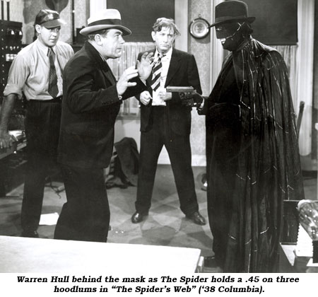 Warren Hull behind the mask as The Spider holds a .45 on three hoodlums in "The Spider's Web" ('38 Columbia).
