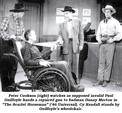 Peter Cookson (right) watches as supposed invalid Paul Guilfoyle hands a repaired gun to badman Danny Morton in "The Scarlet Horseman" ('46 Universal). Cy Kendall stands by Guilfoyle's wheelchair.