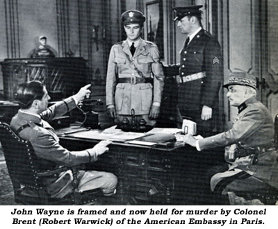 John Wayne is framed and now held for murder by Colonel Brent (Robert Warwick) of the American Embassy in Paris.