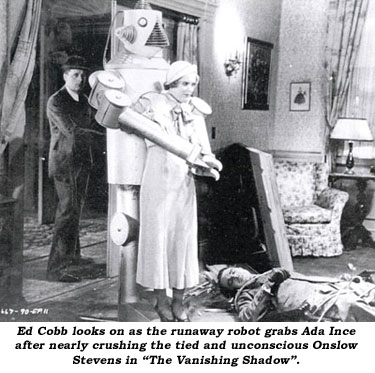 Ed Cobb looks on as the runaway robot grabs Ada Ince after nearly crushing the tied and unconscious Onslow Stevens in "The Vanishing Shadow".