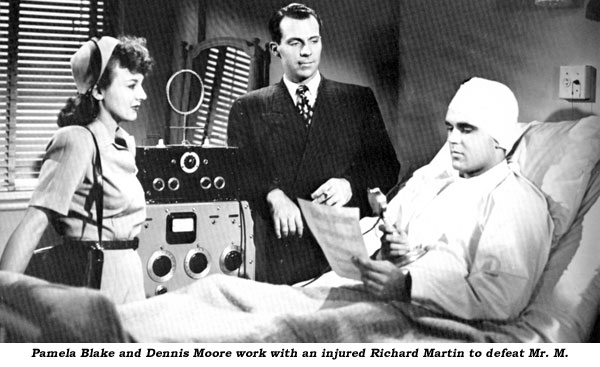 Pamela Blake and Dennis Moore work with an injured Richard Martin to defeat Mr. M.