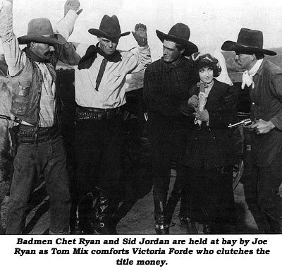 Badmen Chet Ryan and Sid Jordan are held at bay by Joe Ryan as Tom Mix comforts Victoria Forde who clutches the title money.