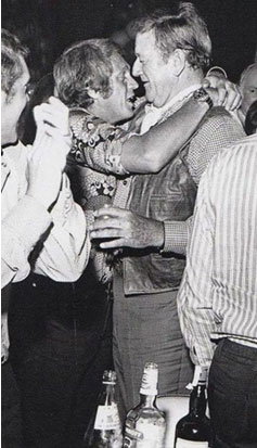 John Wayne seems a bit amused by a very drunken Steve McQueen. 
