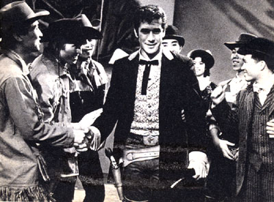 Robert Fuller, star of TV’s “Laramie”, was greeted by some 5,000 Japanese fans in April of ‘61 when he appeared in Japan at the invite of the president of the Pacific Television Corporation and self appointed head of the Bob Fuller Fan Club, Japanese division. Fuller visited six cities in 22 days. In Osaka police estimated the crowd at 500,000. Bob had tea with the Prime Minister and his wife, was photographed with one of the Emperor’s favorite horses, had a friendly Judo bout with one of Japan’s top experts and staged a two-hour TV variety show as a benefit for Japanese orphanages. Bob was presented with the Golden Order of Merit by a personal representative of the Empress. While in Japan he received over 1,000 gifts from fans.