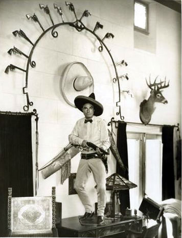 Tom Mix inside his Beverly Hills mansion. The horseshoe shaped arch above him is now in the Dewey, OK, Tom Mix Museum. (Thanx to Bud Norris.)