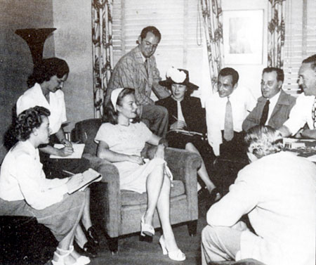 Paramount producer Walter Seltzer (plaid coat) introduces his new find Kristine Miller 
to the press in 1946. 