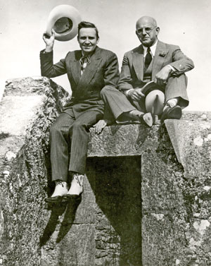 Gene Autry and Republic President Herbert J. Yates sit atop a pillbox in England while Gene was on tour.