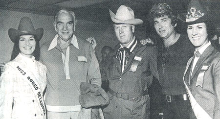 “Bonanza” stars Lorne Greene (second from left) and Michael Landon (second from right) visit with Miss Rodeo Oklahoma (left) and another Oklahoma Rodeo Queen (right). In the center is Jiggs Beutler, son of Elra Beutler, one of the three well known Beutler Brothers whose livestock was well known across the country in rodeo events. Jiggs was a key player in continuing the Beutler and Son Rodeo Company. (Thanx to John Stovall.)