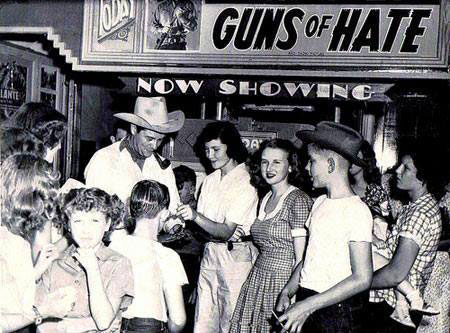 Tim Holt signs a few autographs in August 1948 at the Temple Theatre 
in Mangun, Oklahoma. 