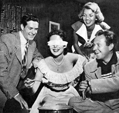 Party time in 1951 Hollywood. (L-R) Hugh O’Brian, Vanessa Brown, Barbara 
Lawrence and Dick Erdman. The game they’re playing involves a timed effort by a blindfolded contestant to pick up scattered pieces of cotton with a spoon and deposit
them in a large pot. 