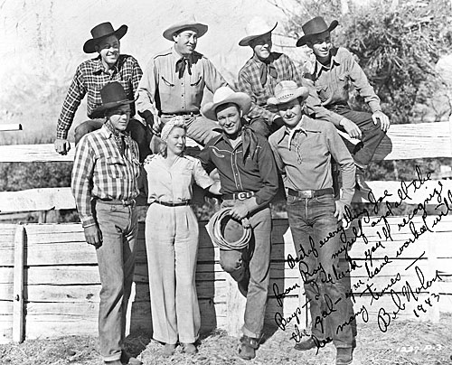 Candid shot taken during the making of “Hands Across the Border” (‘44 Republic). Roy Rogers and the Sons of the Pioneers with veteran stuntwoman Nellie Walker. Bob Nolan inscribed the photo to former stuntman and serial star Joe Bonomo who had worked with Nellie years before. (Courtesy Ed Hulse.) 