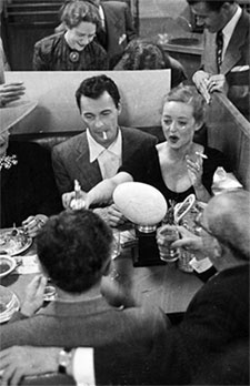“The Tall Man”—Barry Sullivan dines with Bette Davis. 