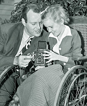 “High Chaparral”—Leif Erickson helps a young fan with her camera. 