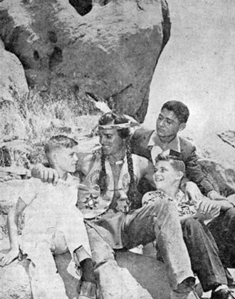 On the set of “Brave Eagle”, produced by Roy Rogers, are Jerry Thompson, Joe Howley and Pete de la Santos, newsboy carriers from the SAN ANTONIO NEWS EXPRESS. They were guests of Roy in Hollywood after winning a big circulation contest when Roy appeared in San Antonio with his championship rodeo. Keith Larsen was the star of “Brave Eagle”.