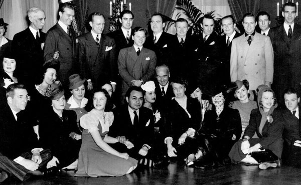 Eleanor Roosevelt’s 1941 birthday celebration at the White House. Can you spot Red Skelton, Kay Kyser, Tyrone Power, Mickey Rooney, Pat O’Brien, Gene Autry, Edward Everett Horton, Elsa Lancaster, Ginny Simms, Deanna Durbin, Edward G. Robinson, William Boyd, Eleanor Roosevelt (right of Boyd), Olivia de Havilland, James Cagney. (We understand William Boyd was upset that Gene Autry wore a Western suit instead of a regular dress suit.)
Can you spot any celebrities we’ve missed? 