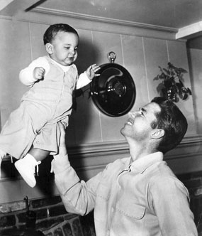 Audie Murphy holds high not quite 2 year old son, James “Skipper” Shannon, in 1956.