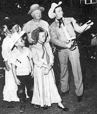 Celebrating the premiere of “The Last Command” (‘55 Republic), in Uvalde, TX, Ben Cooper, one of the stars of the film, stopped to call on John Nance Garner, former Vice President of the United States, where some young direct descendents of the heroes of the Alamo were introduced to Nance and Cooper. 