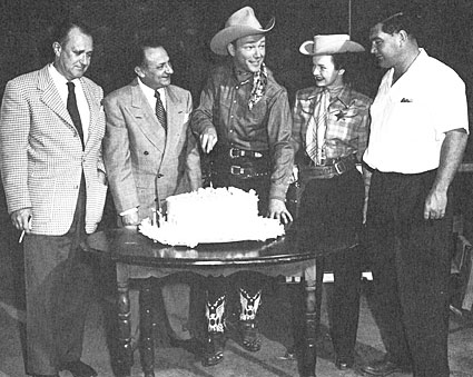 Roy Rogers celebrates 12 years at Republic. Dale Evans and director Bill Witney 
are on the right. 