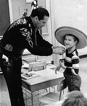 During the 12th annual Shrine Showdeo at the Minnesota State Fair, Duncan Renaldo, the Cisco Kid, makes a young fan very happy by letting him try on his sombrero. (Thanx to Terry Cutts.) 