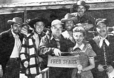 On the set of “Apache Ambush” (‘55 Columbia)...director Fred Sears, star Bill Williams to his right, leading lady Adelle August to his left...and is that Clayton Moore between Sears and August? Other three unknown. 