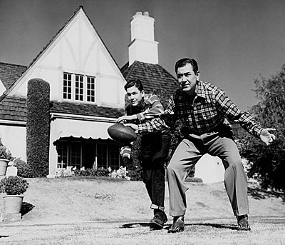 Johnny Mack Brown passes the ball to son John Lachlan as they play backyard football.