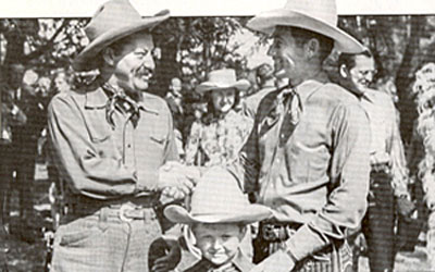 Montie Montana shakes hands with comedian Jerry Colonna. That’s Montie’s young son Montie Jr. in the middle...and...is that stuntlady actress Evelyn Finley between Montie and Jerry? 