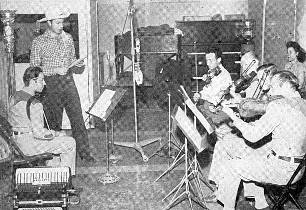 Tex Williams and Pedro de Paul listen attentively as the fiddle players rehearse a final arrangement for one of Tex’s Capitol recordings. (‘50) 