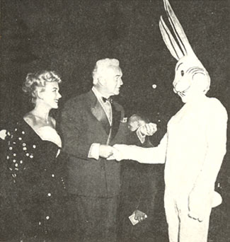 William (Hopalong Cassidy) Boyd, accompanied by his wife, Grace Bradley, presents his card to Harvey, the unseen giant rabbit of the James Stewart starrer of the same name in 1950.