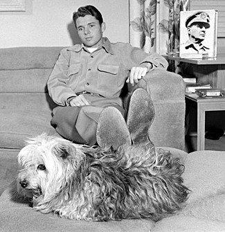 A pensive Audie Murphy relaxes at home. 