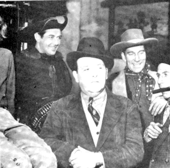 Johnny Mack Brown with Universal serial producer Henry MacRae. Unknown
players on the right. 