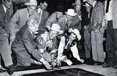 Sid Grauman for the famous Chinese Theatre helps Roy place his six-gun in Grauman’s cement Hall of Fame in April 1949. In the background Foy Willing and the Riders of the Purple Sage including Pat Brady. Hoot Gibson and Eddie Dean on the far right. 