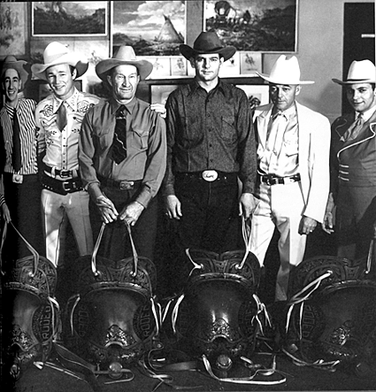 Rodeo Champions of 1942. World Championship Rodeo at Madison Square Garden. (L-R) Jerry Amblen (Saddle Bronc), Roy Rogers, Erbie Munday (Wild Calf Milking), Jack Favors (Steer Wrestling), Mr. Colburn (Rodeo Producer), Dick Griffin (Bull Riding). 