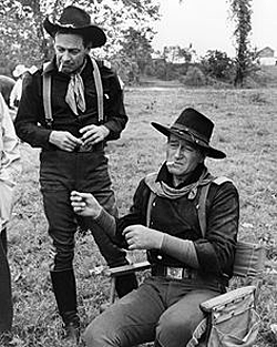 William Holden and John Wayne take a break during the filming of “The Horse Soldiers” (‘59 UA). 